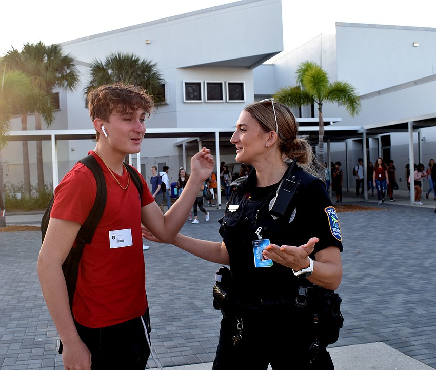 Bron Moncelli says hi to Officer Amber DeFrancisco on his way to his next class.