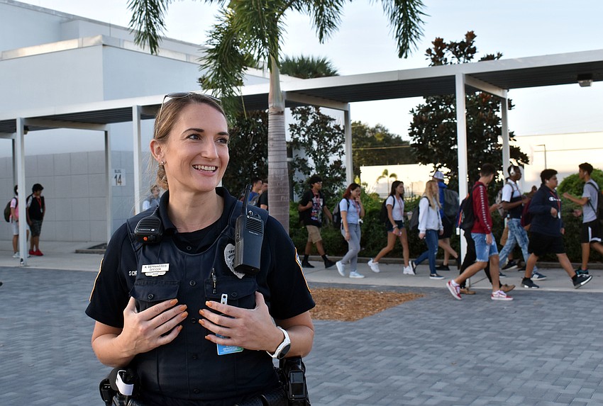 Officer Amber DeFrancisco greets students in between classes.