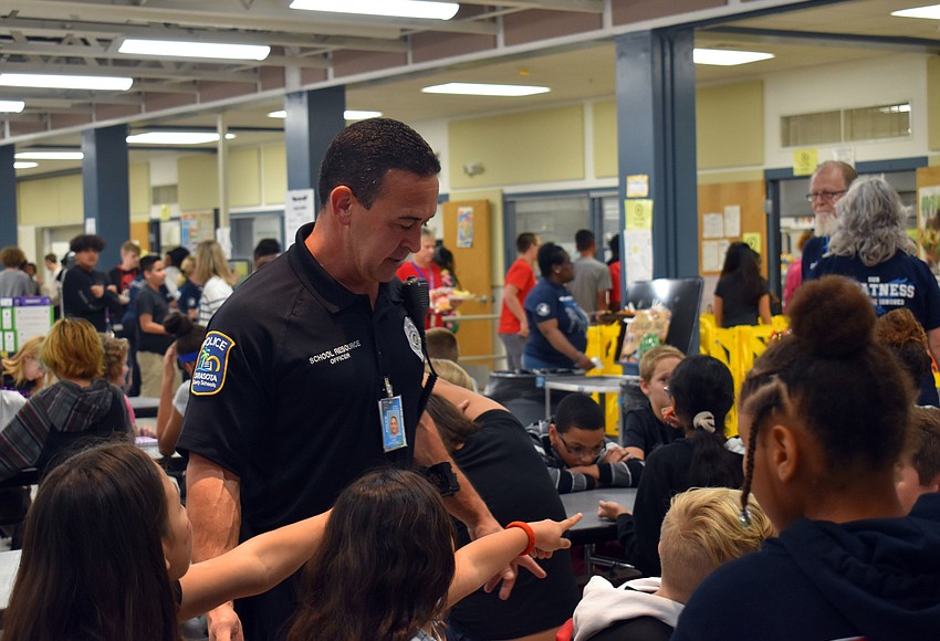 Your Observer Photo Officer Anthony Limite talks to McIntosh Middle