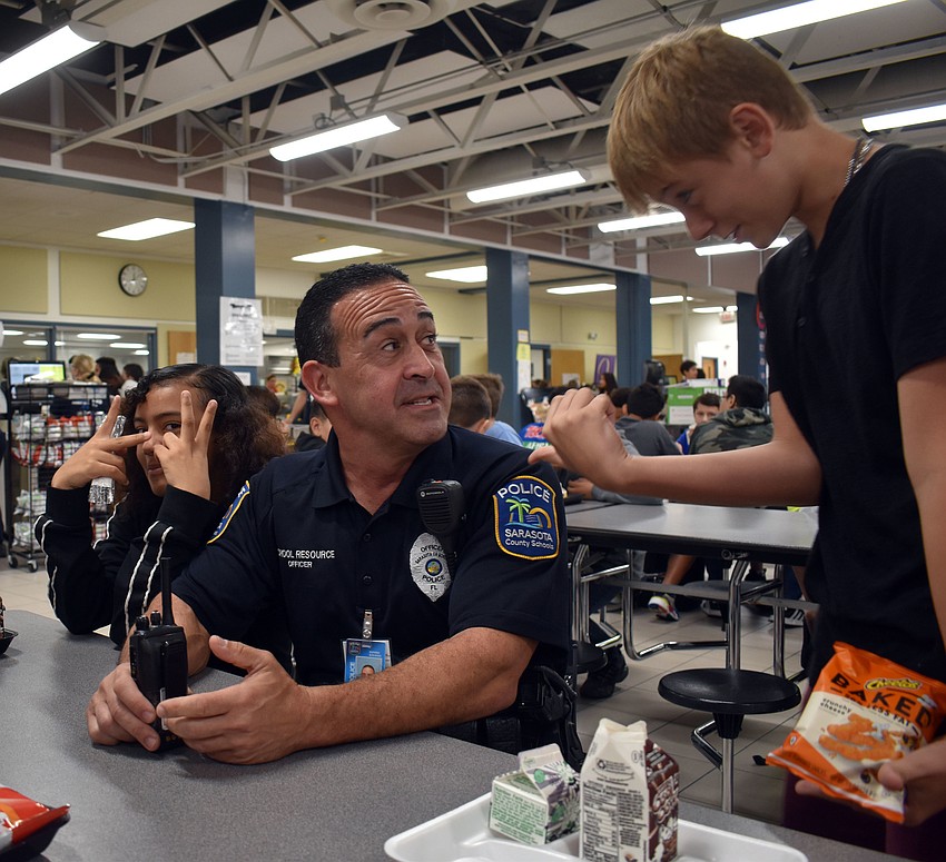 Officer Anthony Limite chats with McIntosh Middle School student Zack Renner.