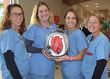 Scrub techs Ashley Warren and Katie Corso and nurses Rachel Zera and Lyn Swann presented the Widow-maker pumpkin.