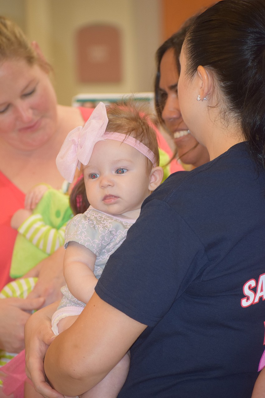 Gemma Courtenay goes down the parade route with mom, Kristina Courtenay. She was born June 21.