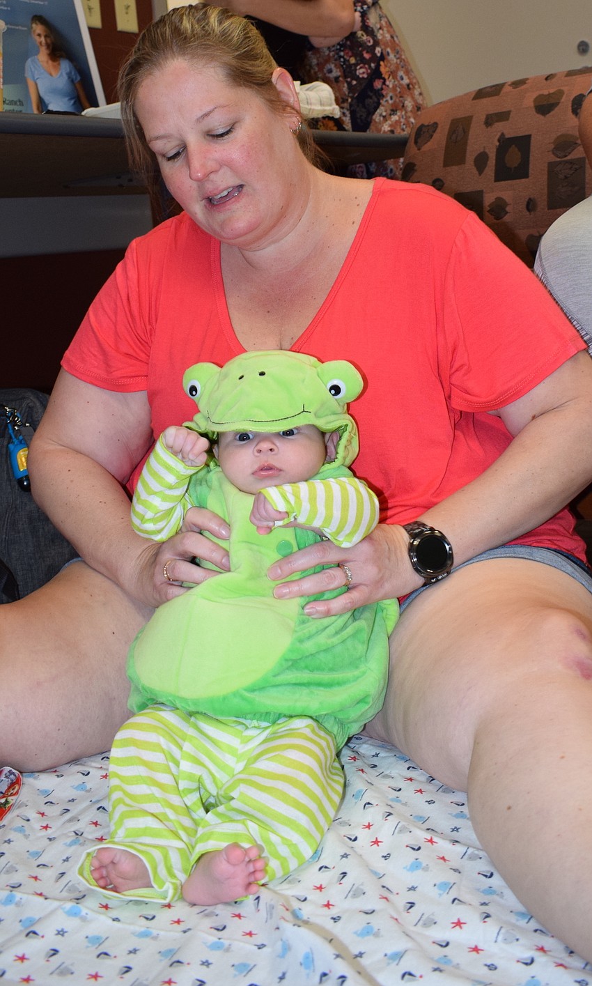 Coleson Rosati sits with mom, Bradenton's Angel Rosati, before beginning the parade. Coleson, who was born Aug. 16, wore a turtle costume.