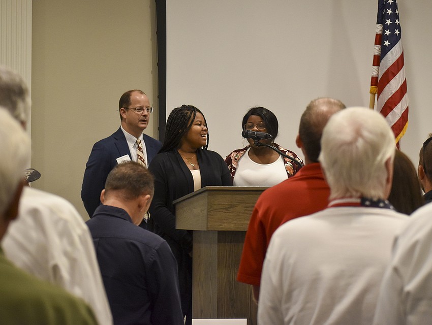 Members from the Booker High School Key Club lead the audience in a rendition of 