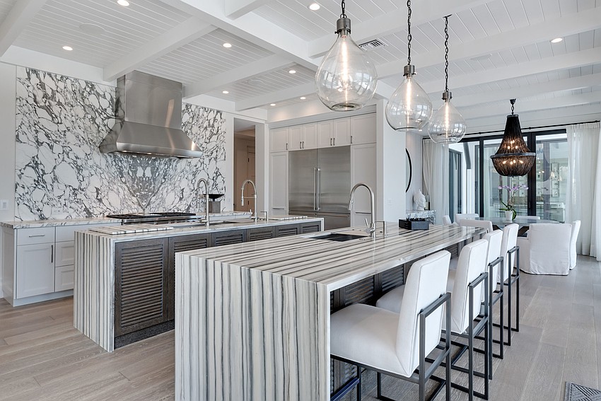 A gourmet kitchen features Campbell Cabinetry Designs and Zebrino white marble countertops. (Photos courtesy: Premier Sotheby’s International Realty)