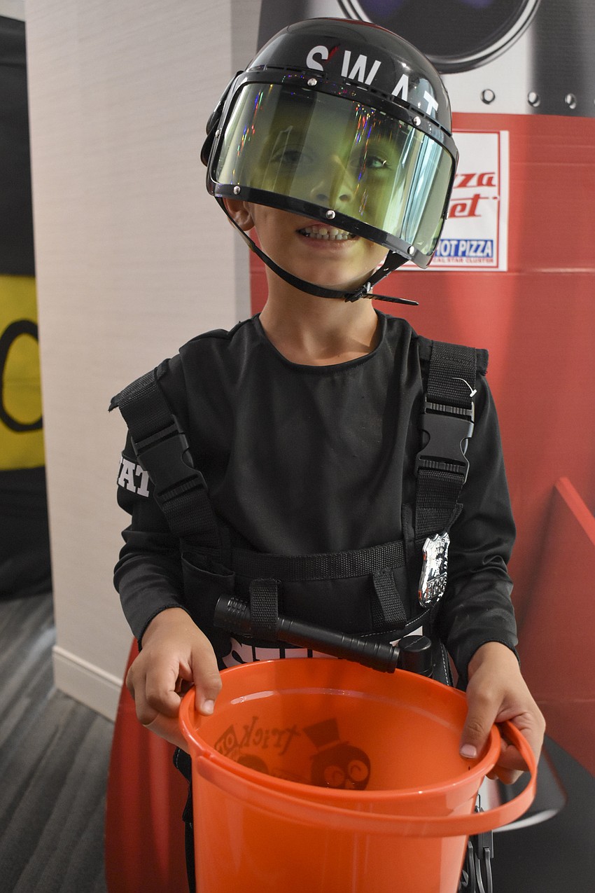 Johnny King, 6, holds up his candy bucket.
