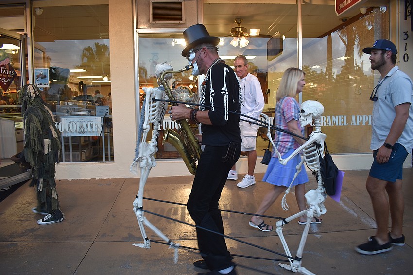A gang of saxophone skeletons dances past.