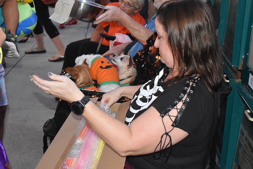 Keirsten Showalter passes out glow sticks.