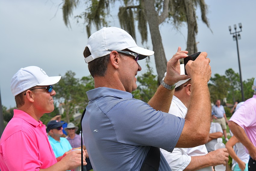 Member Brad Brautigan videos as golfer Tony Jacklin takes the first shot on the Gimme course.