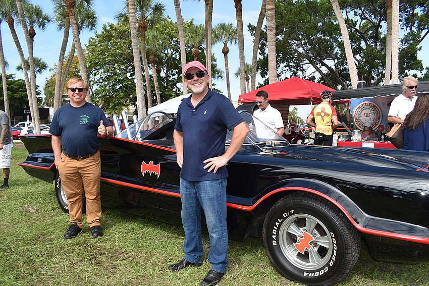 Eugene and John Nock stand with Eugene's Batmobile.