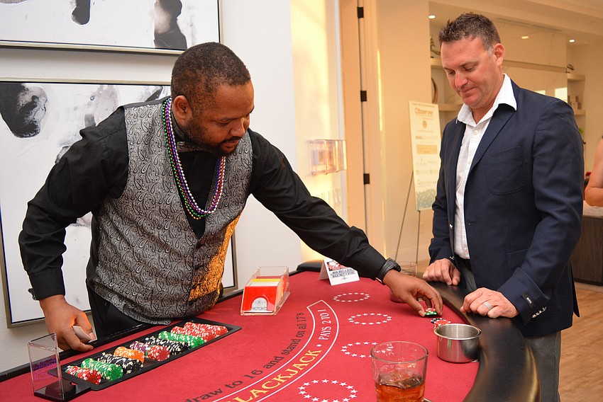 Dealer Anthony Leesbott deals Mill Creek's Brian Pintacuda with a game of blackjack.