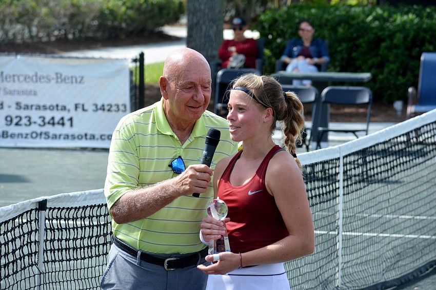 Dick Vitale hands the women's championship trophy to Oklahoma sophomore Marcelina Podlinksa.