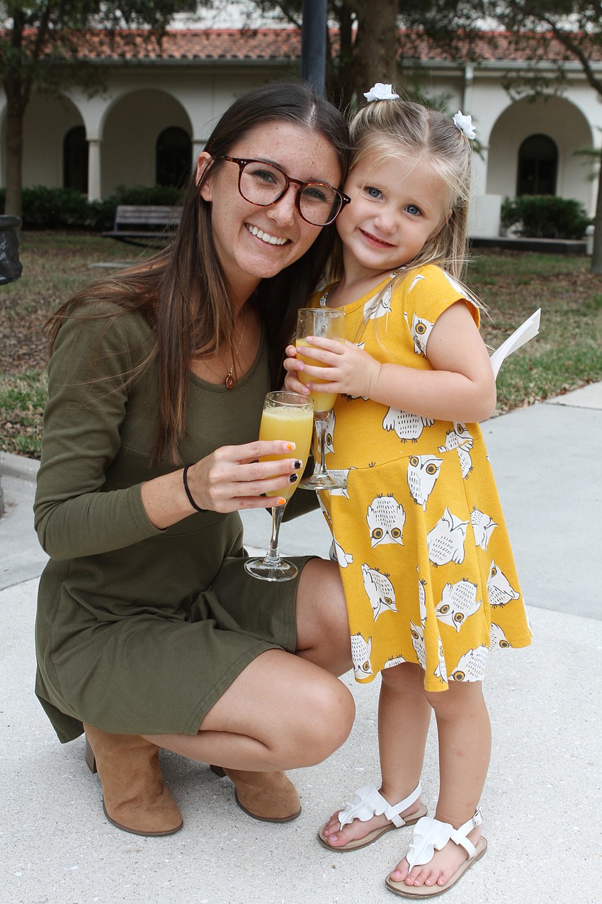 Kayla and Madelyn Kehoe with her orange juice.