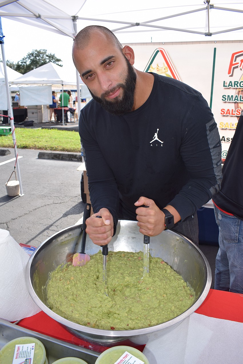 Dynasty Guacamole owner Assiel Landa mixes a batch during the Market at Lakewood Ranch.