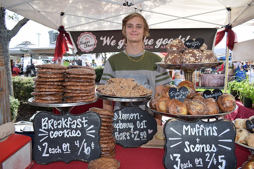 Employee Dakota Lyons stands behind the counter of 50 Donuts and Sift Bakehouse goods.