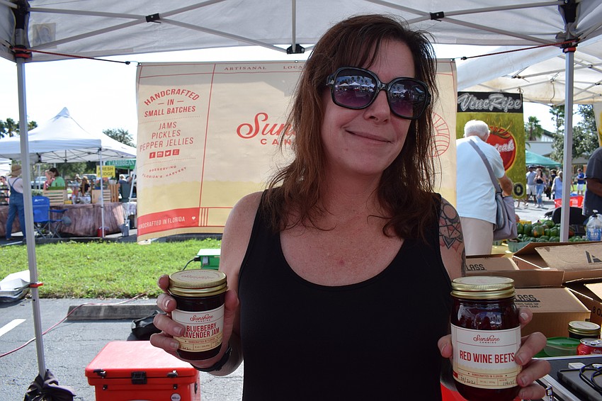 Sunshine Canning owner Lisa Fulk shows off some of her canned goods she is selling at the market.