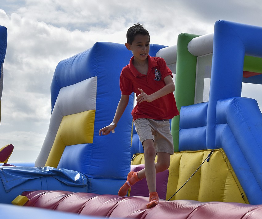 Alex Johnson, 10, runs across the blow-up balance beam.