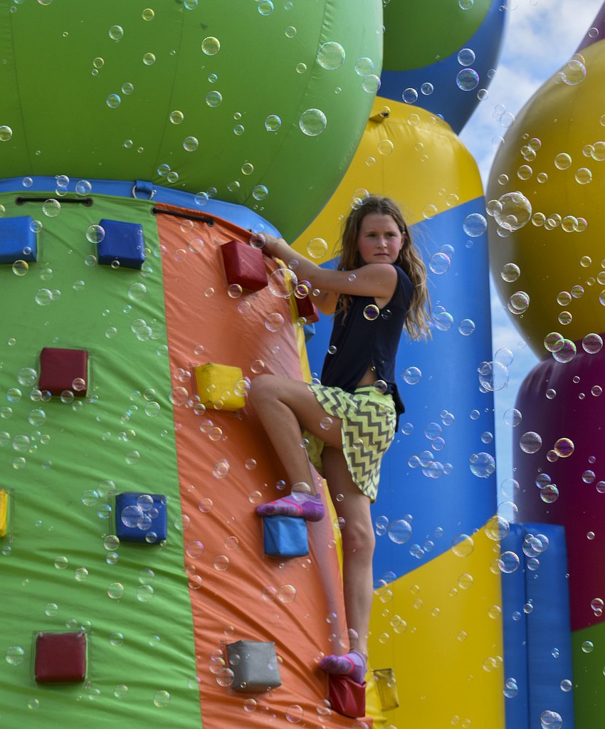 Kenzi Kondrup, 11, looks out from the top of the climbing wall.