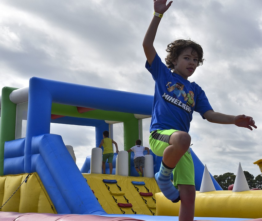Landon Bruns, 8, balances on the inflatable balance beam.