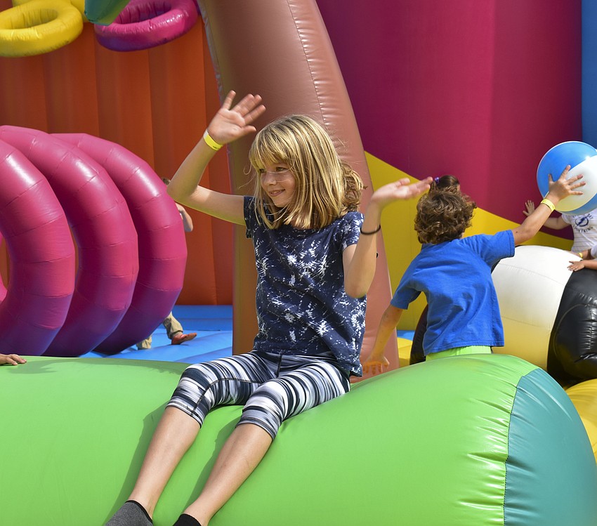 Mariska Figueroa, 11, waves her hands in the air at the DJ's instruction.