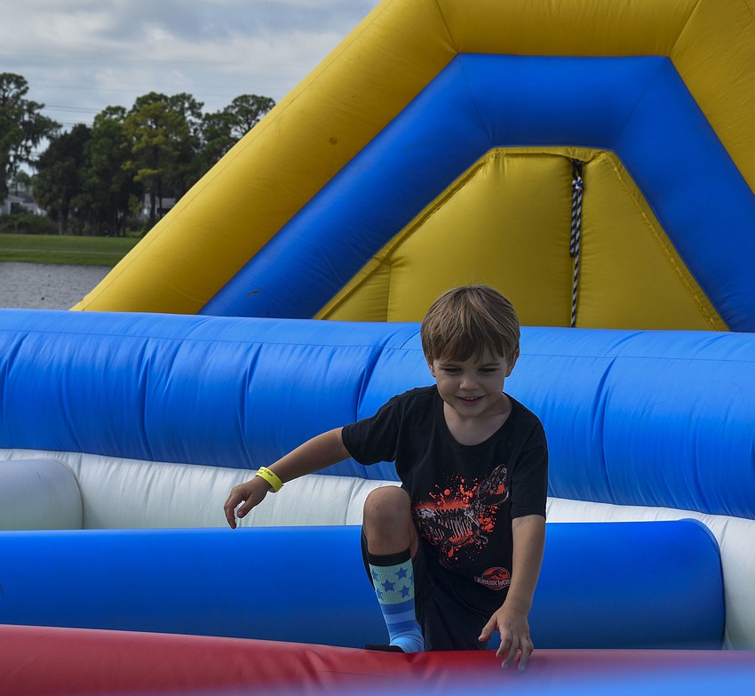 Nolan Bruns, 5, climbs his way through the obstacle course.