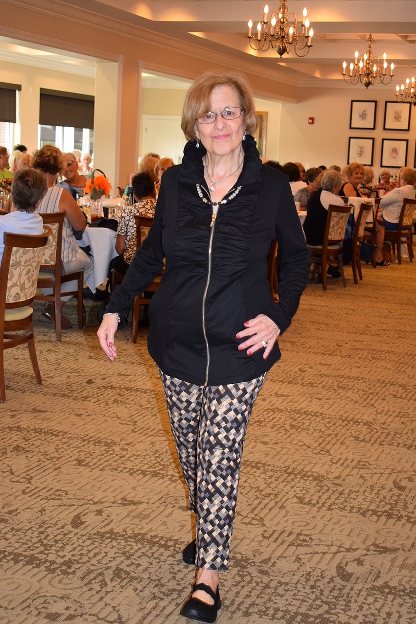 Tara resident Ellen Ruggiero struts around the main dining room modeling clothes from Soft Surroundings. Ruggiero has been a member of the Tara Golf and Country Club for 26 years.