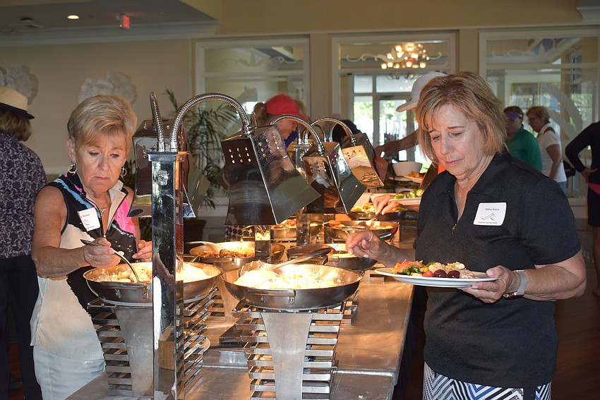 Women helped themselves to a buffet after the round of golf.