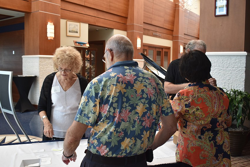 Andy Maass and Tessie Jose welcome members in like Lois Barson.