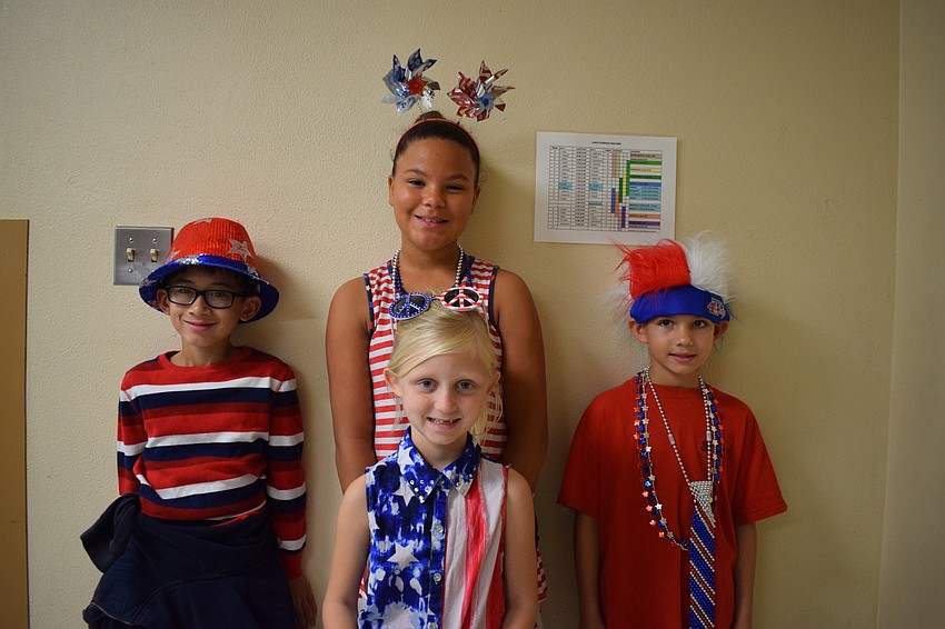 Jayden Bui, Chloe Randall, Ayden Willis and Raylin Hagood (front) wear patriotic clothes for Tara Elementary's Veterans Day ceremony.