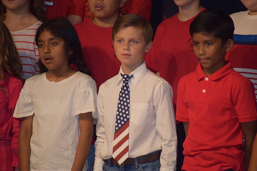 Fourth-graders Gloria Guerrero, Shaun Teta and Sameek Choudhury sing 