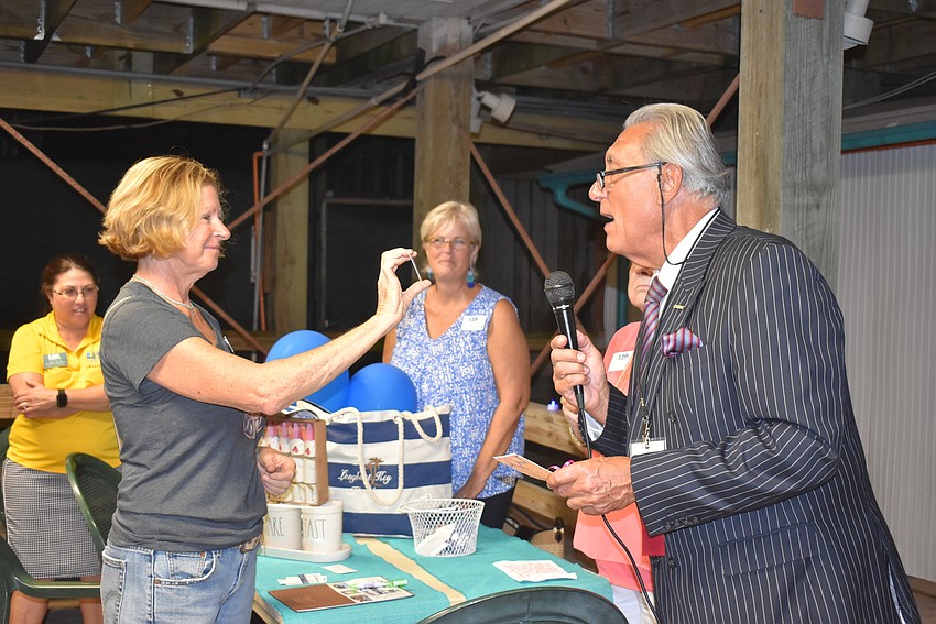 Debby McClung comes up to claim her prize.