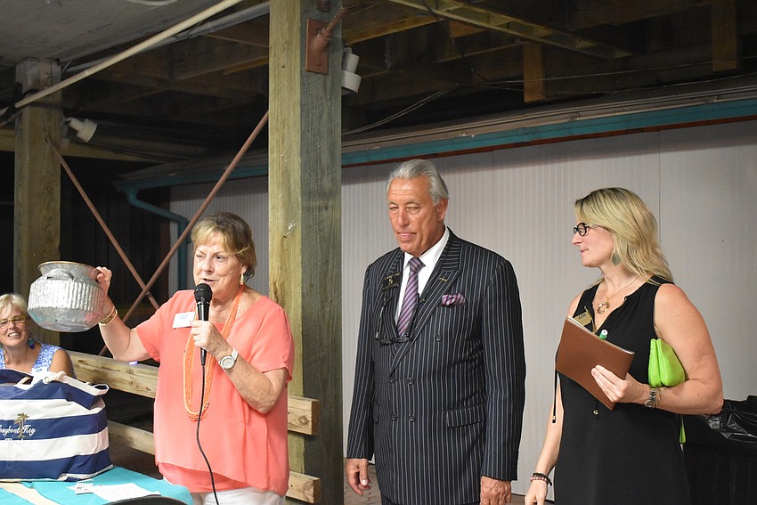 Gail Loefgren, Andrew Vac and Tonya Atchison prepare to pick the winner of Each One Reach One.