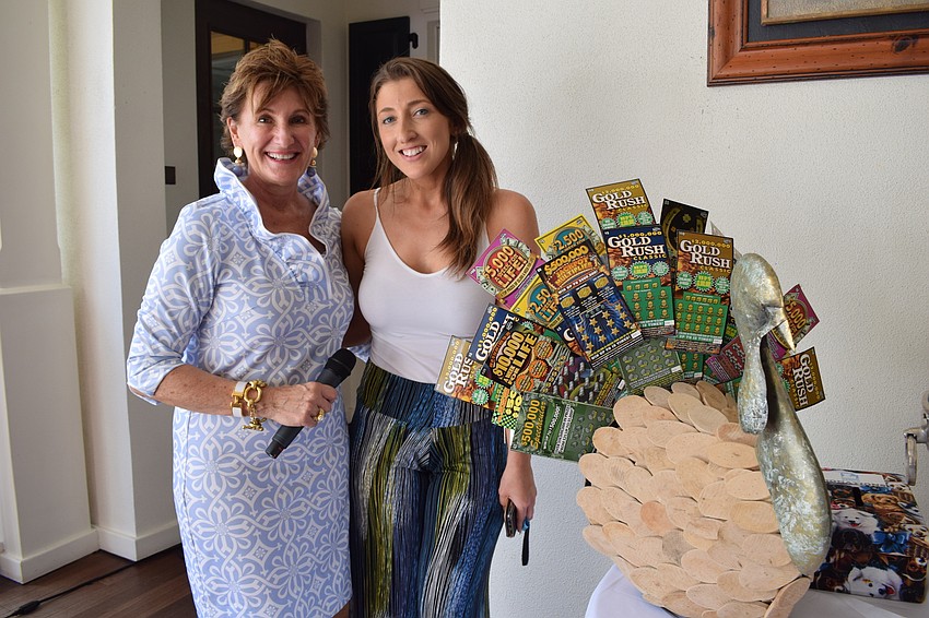 Susan Giroux, a vice president of the Humane Society of Lakewood Ranch, presents the lottery ticket turkey to Lakewood Ranch's Kasie Rubin, who won the raffle.