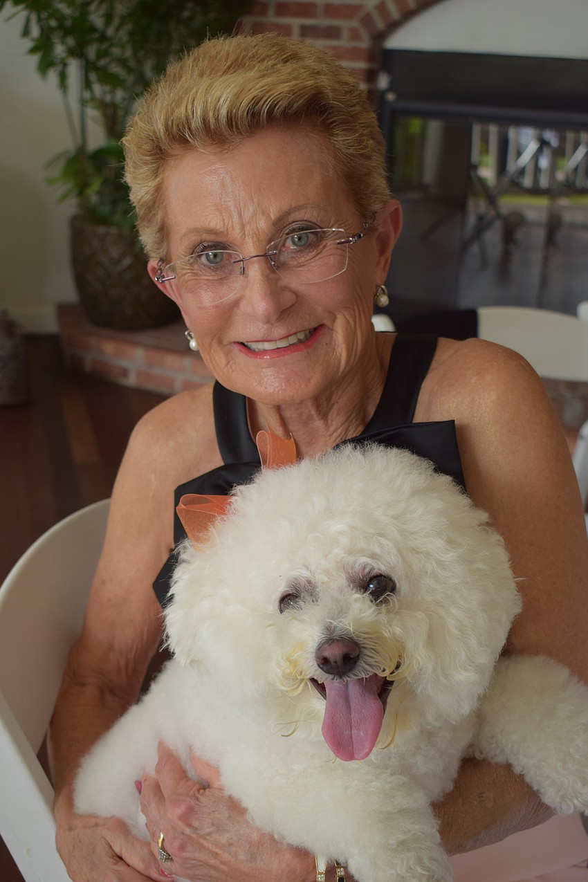 Lakewood Ranch's Mary Jo Hansen gets ready to send her dog, Lulu, out to the runway for the fashion show.