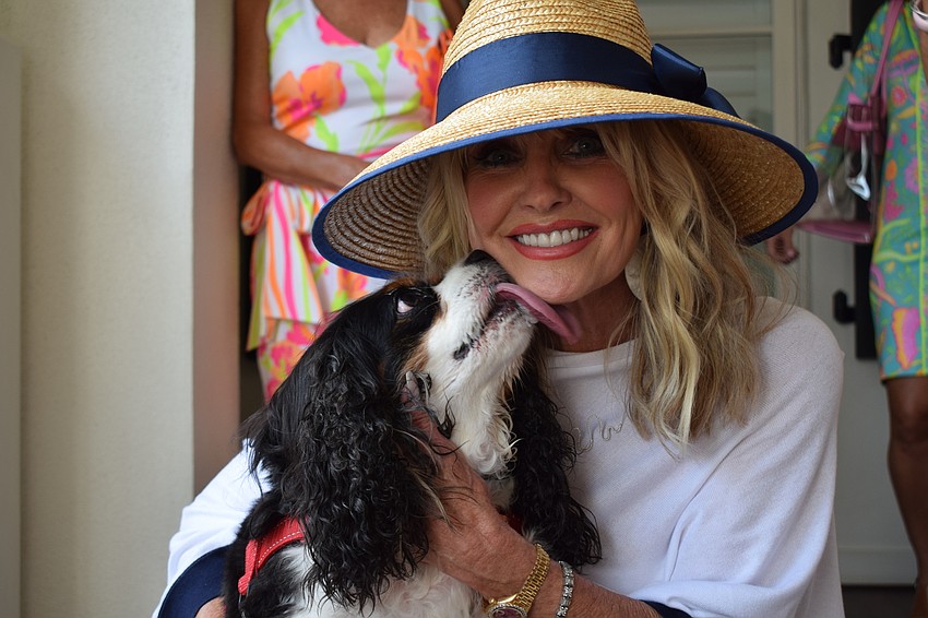 Brody gives owner Donna Brierton of Lakewood Ranch a kiss for a job well done after she modeled Twist Boutique clothing.