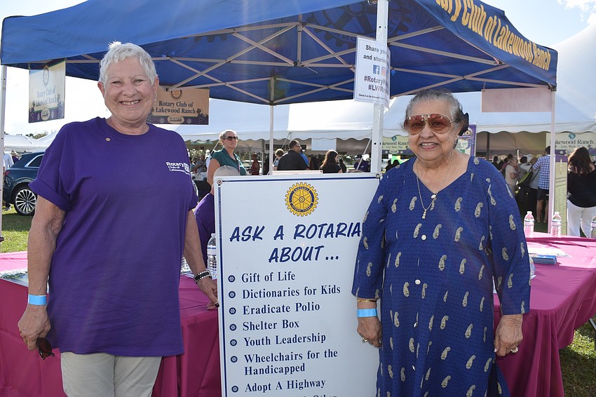 Joyce Borda, public information chair for the Rotary Club, talks to Mona Jain about becoming a member of the Rotary Club.