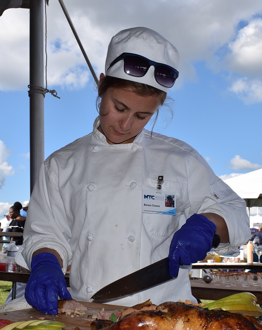 Alexis Conzo, a culinary student at Manatee Technical College, prepares roast duck with a pear and hot honey sauce sample.