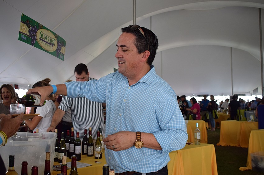 Zac Mendiola of Monsieur Touton Wines pours a glass during the annual Suncoast Food and Wine Fest.