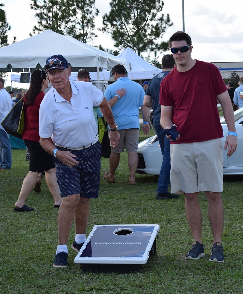 Lakewood Ranch resident Jorgen Hansen and Sarasota resident Blake Caldwell play cornhole.