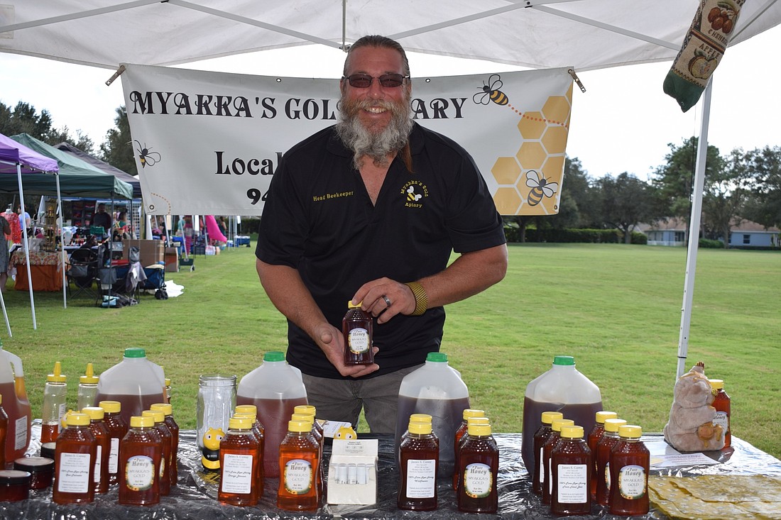 James Cutway, president of the Suncoast Beekeepers Association and owners of Myakka&#39;s Gold Apiary, sells local, raw honey at the Who Knew Pop Up Market at Summerfield Park.