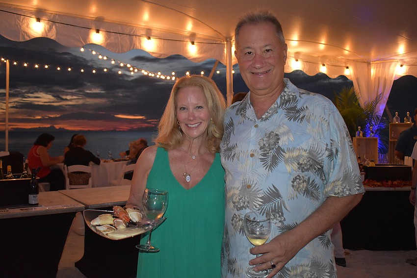 Catherine Avery and Jeff Cianci with wine and food.