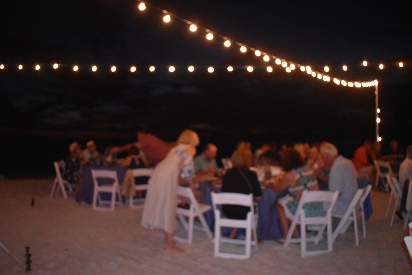 Outside the tent, soft light illuminated the dining area.