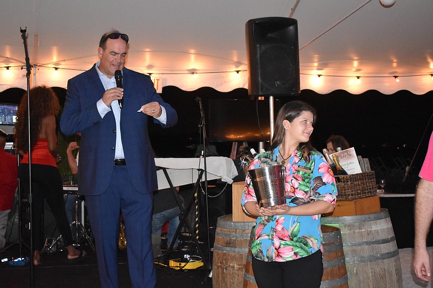 Host auctioneer Andrew Ford and USF student Sarah Paul.