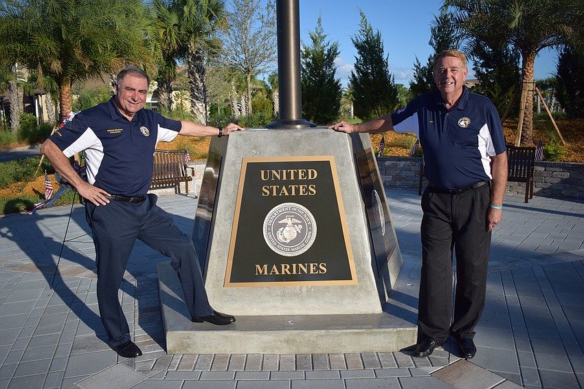 Herman Martinez and Jerry Hufford stand alongside the Circle of Honor memorial that was dedicated by the Association of Veterans and Military Supporters and the Pulte Group Southwest Florida Division at Del Webb.