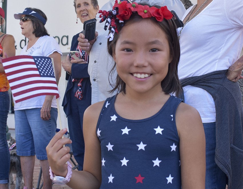 Julia Stochl, 8, sports a red flower crown to complete her red, white and blue outfit.