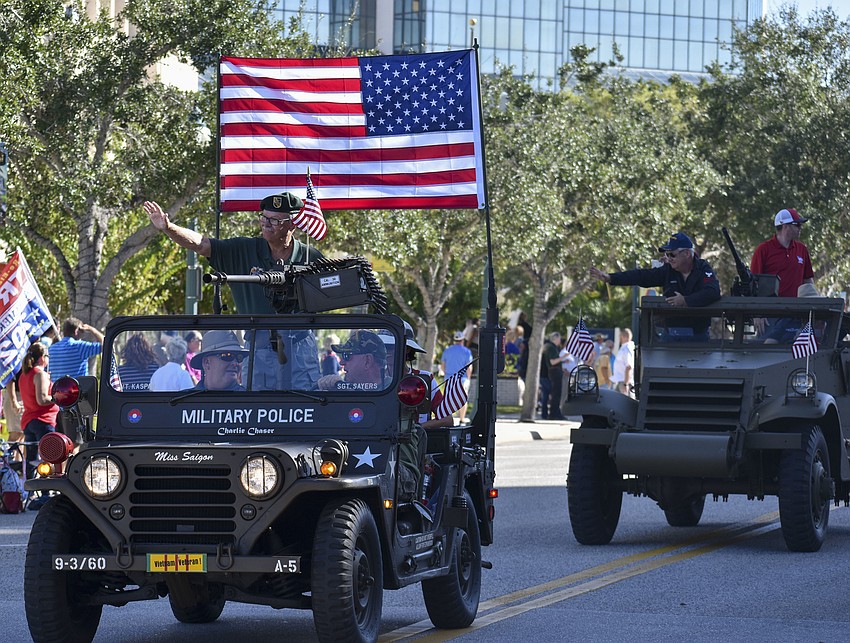 Military Police veterans wave to the crowd.