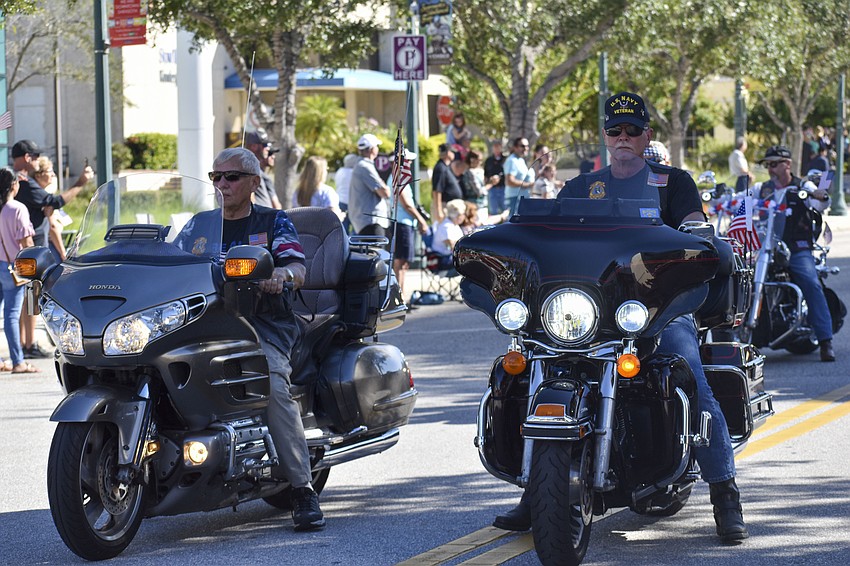 Members of the American Legion Post 266 ride through the parade on motorcycles.