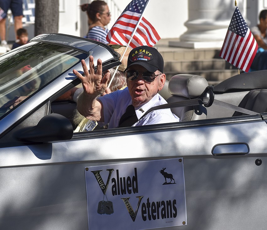 A member of Valued Vets waves to the crowd.