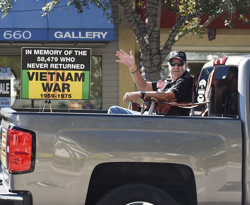 Members of the Vietnam Brotherhood drive down Main Street.