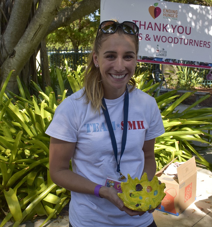 Jamie Testa shows off one of the voucher bowls.